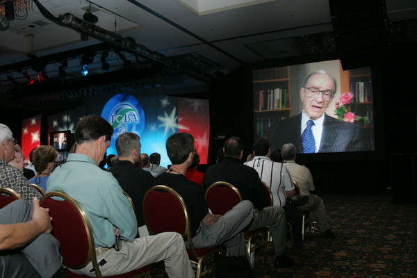 Alan Greenspan addresses his audience via video